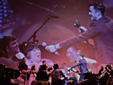 Playing guitar at the Orpheum with JGL and a bunch of audience volunteers on the floor.